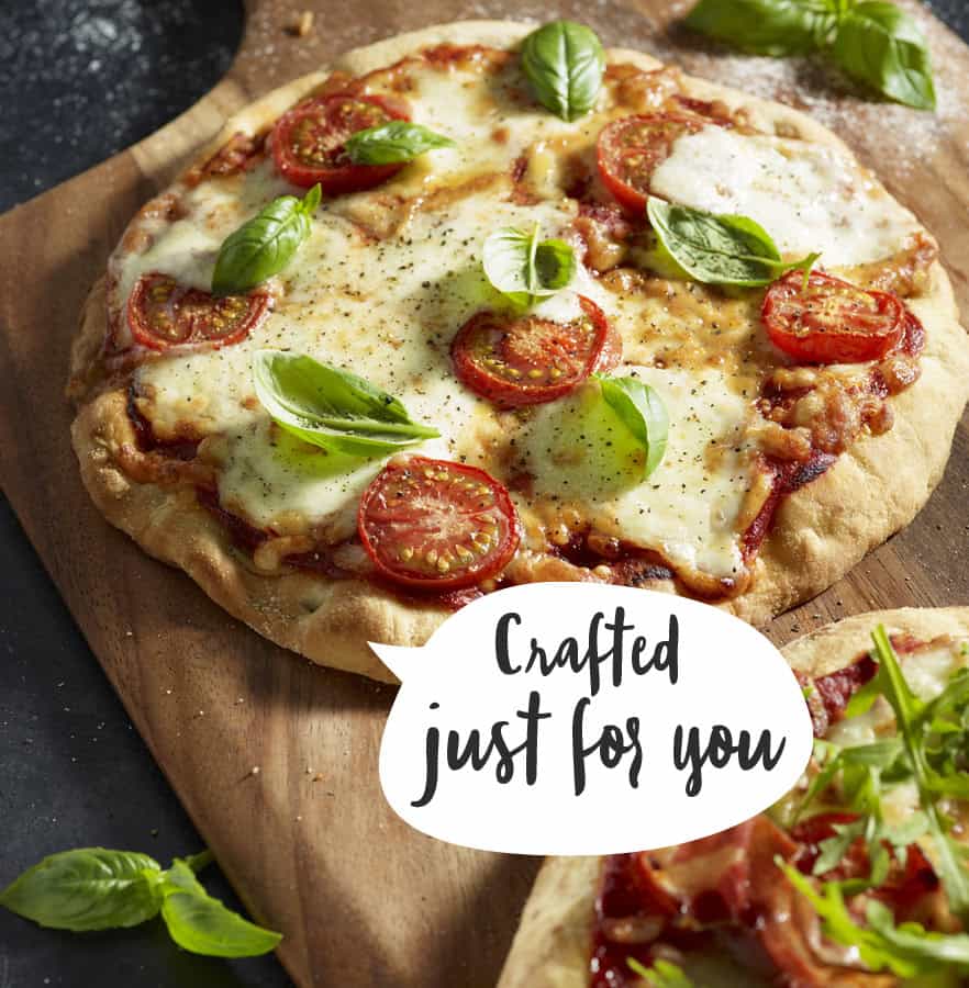 Fresh margherita pizza with tomatoes and basil leaves