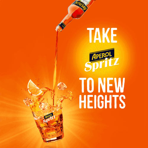 Aperol Spritz drink being poured into a glass.