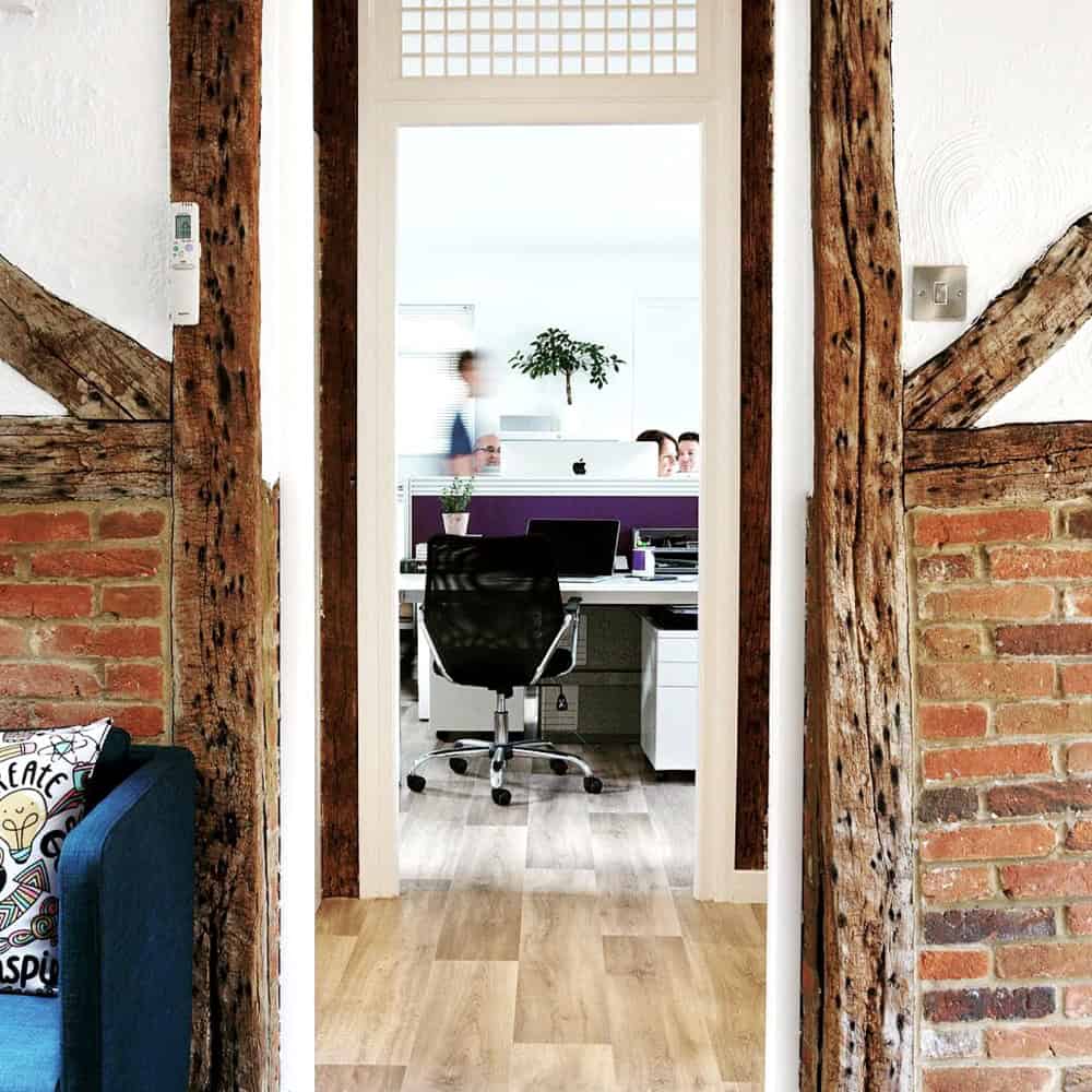 View into modern office through rustic doorway